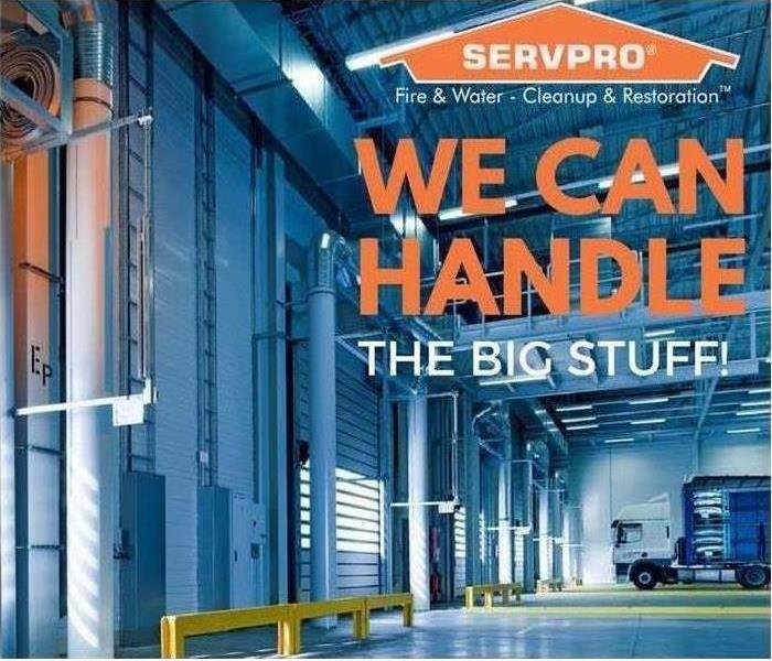 Inside a large warehouse with the SERVPRO logo and the words "We can handle the big stuff."