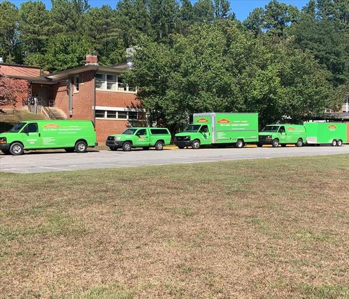 SERVPRO vehicles lining the front of Tenth Street Elementary School.