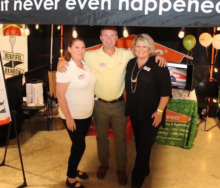 3 SERVPRO employees at the SERVPRO booth at the EXPO.