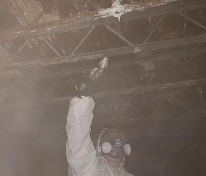 A SERVPRO employee soda blasting mold in a crawlspace.